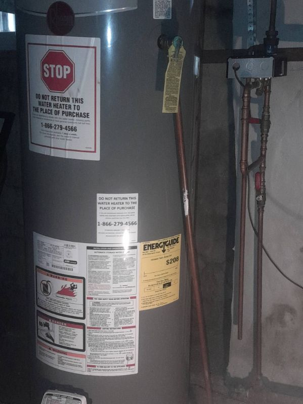 Residential water heater installation with copper piping and code-compliant connections
